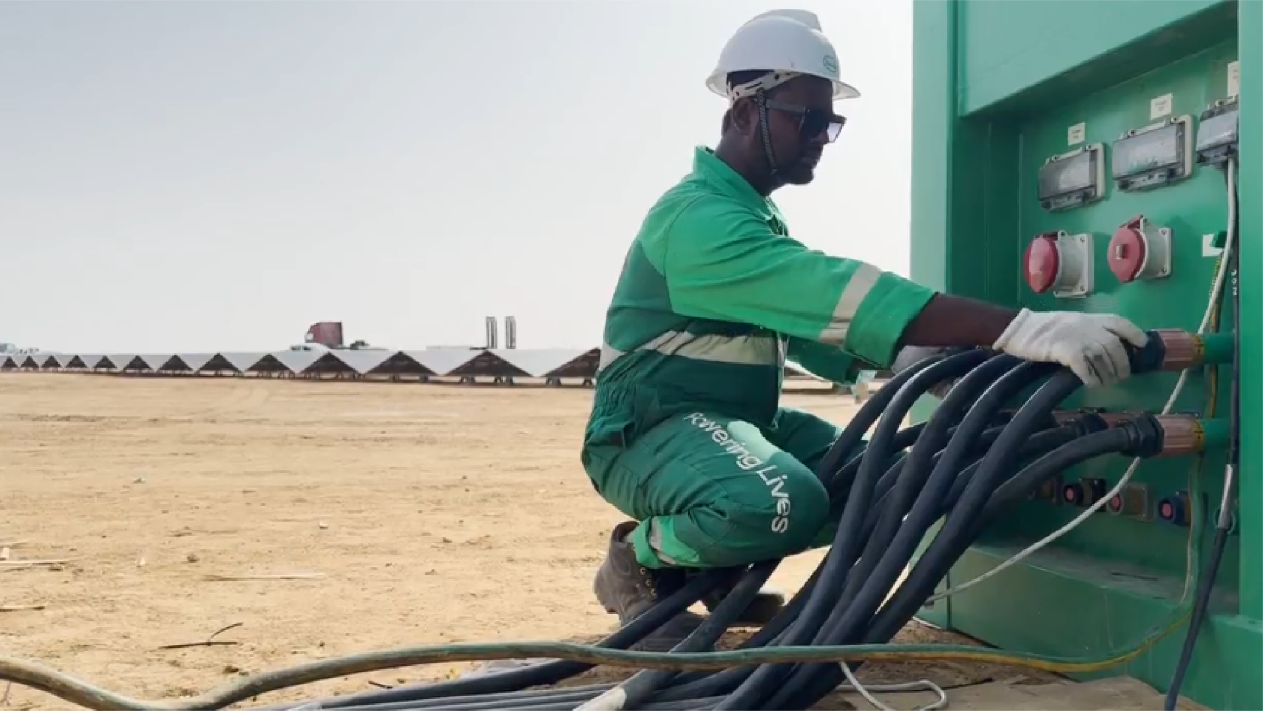 Energia technician connecting cables to a power distribution unit